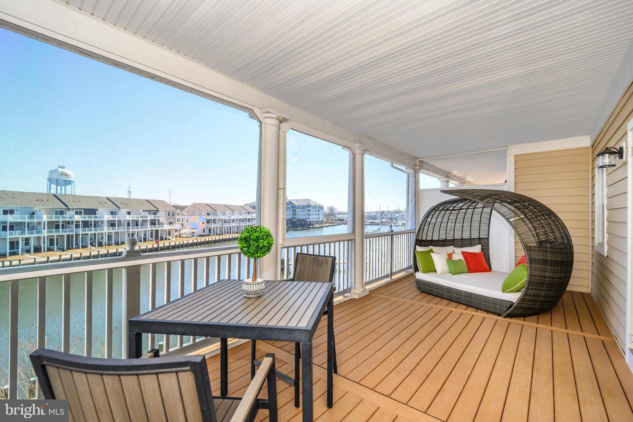 202 Muir Street, Unit 202 Cambridge, MD 21613 - Photo 28 of 54 a view of a balcony with furniture and wooden floor