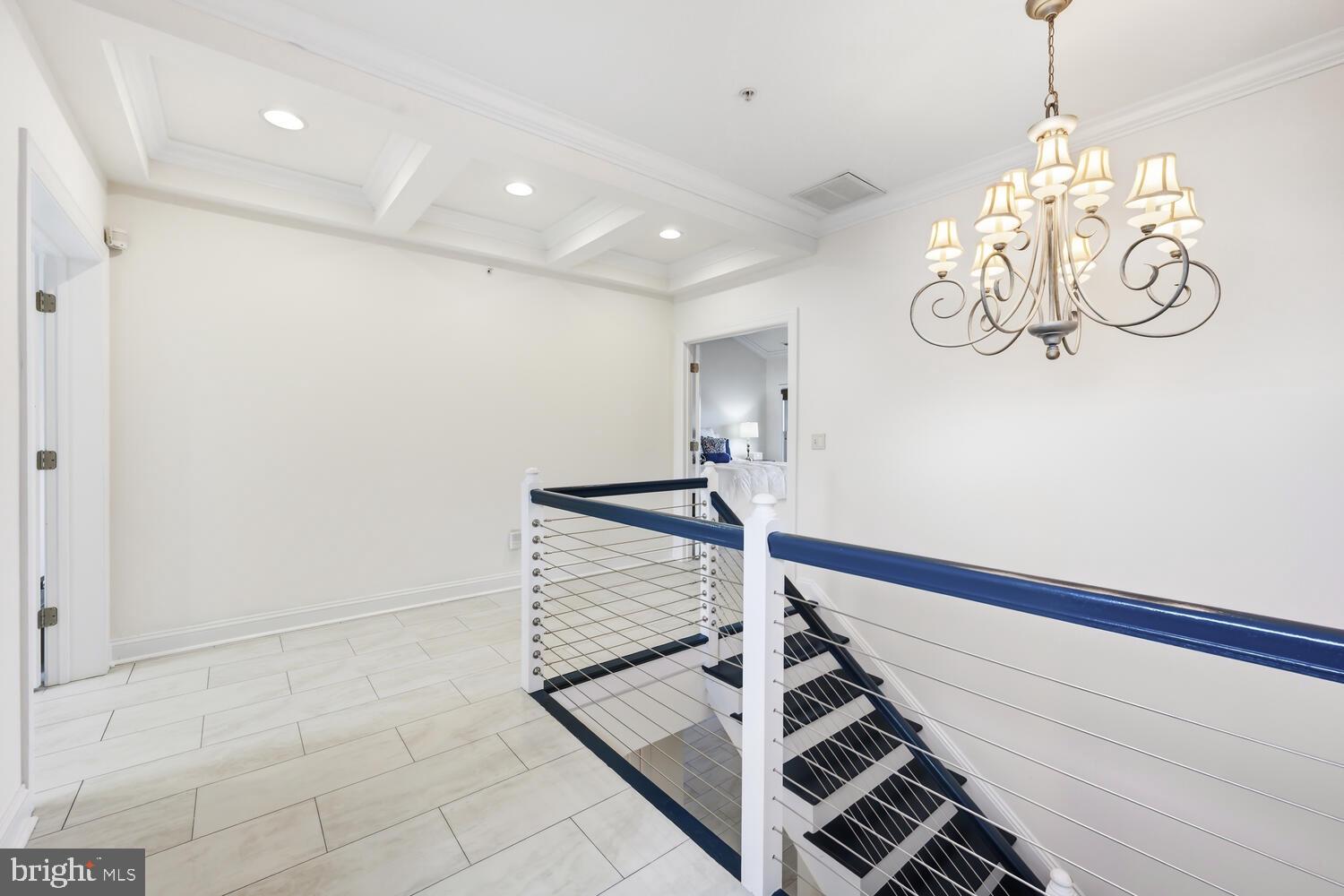 202 Muir Street, Unit 202 Cambridge, MD 21613 - Photo 34 of 54 a view of a chandelier and staircase