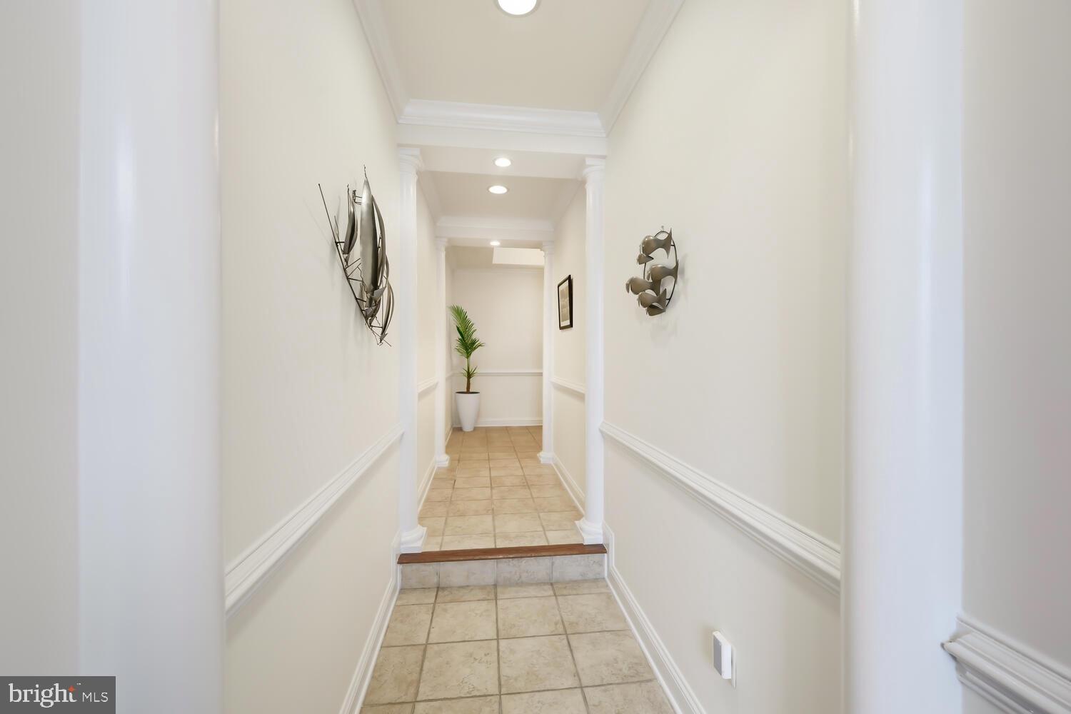 202 Muir Street, Unit 202 Cambridge, MD 21613 - Photo 38 of 54 a view of a hallway with wooden floor and staircase