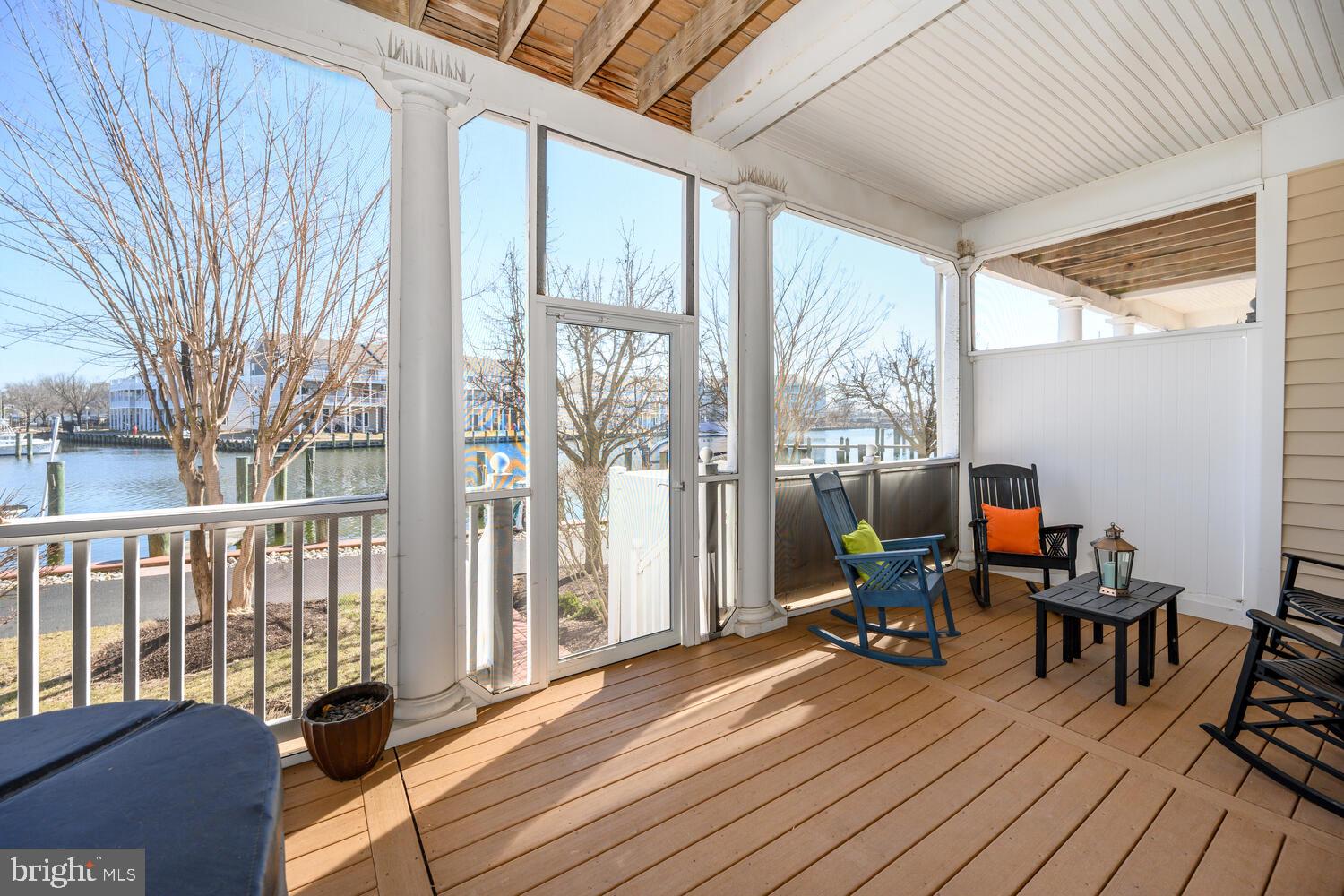 202 Muir Street, Unit 202 Cambridge, MD 21613 - Photo 4 of 54 a view of a balcony with chairs and wooden floor