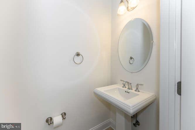 202 Muir Street, Unit 202 Cambridge, MD 21613 - Photo 41 of 54 a bathroom with a sink mirror and vanity