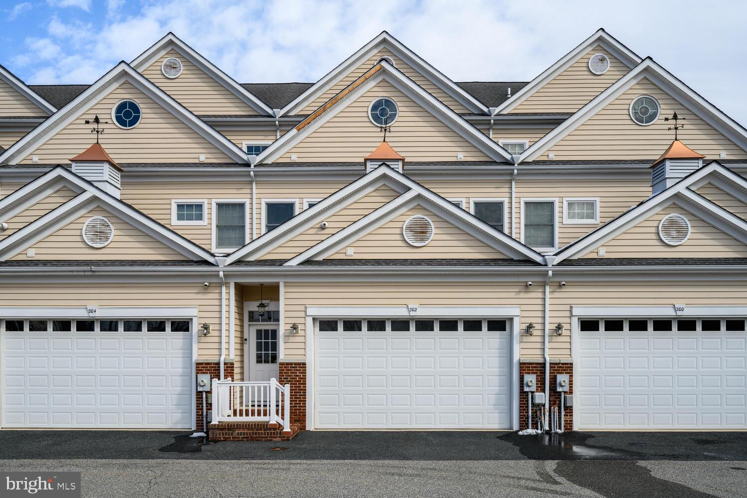 202 Muir Street, Unit 202 Cambridge, MD 21613 - Photo 51 of 54 a view of a white house with a clock on the top