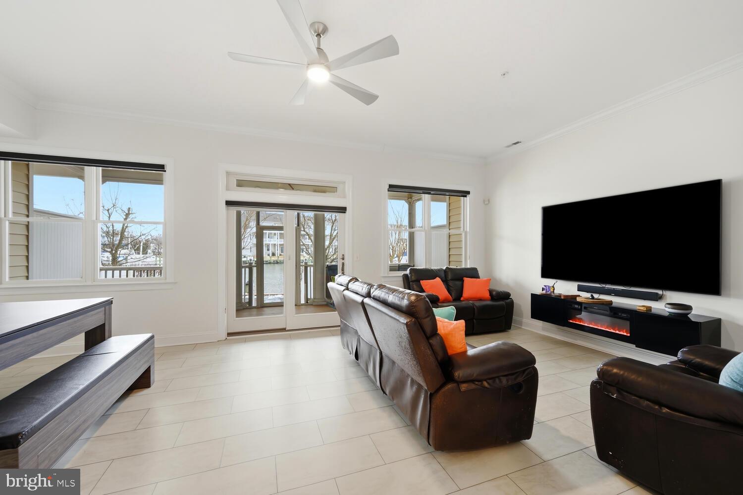 202 Muir Street, Unit 202 Cambridge, MD 21613 - Photo 6 of 54 a living room with furniture and a flat screen tv