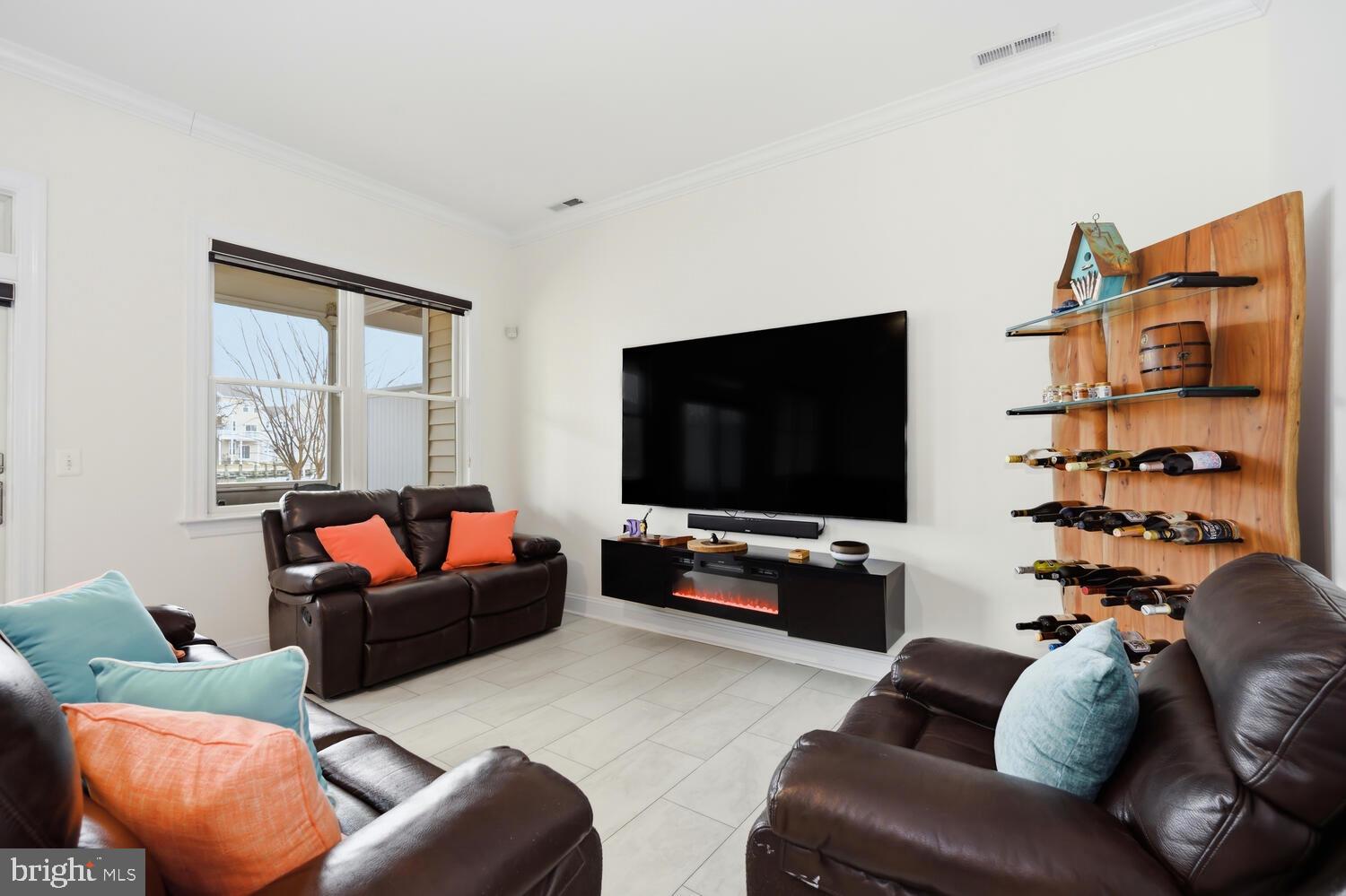 202 Muir Street, Unit 202 Cambridge, MD 21613 - Photo 8 of 54 a living room with furniture and a flat screen tv