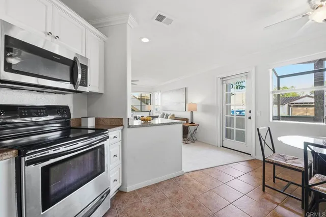 a kitchen with a stove a microwave and wooden cabinets