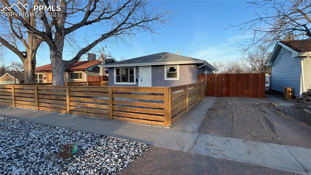 1219 Prairie Road Colorado Springs, CO 80909 - Photo 1 of 16 a front view of a house with a yard