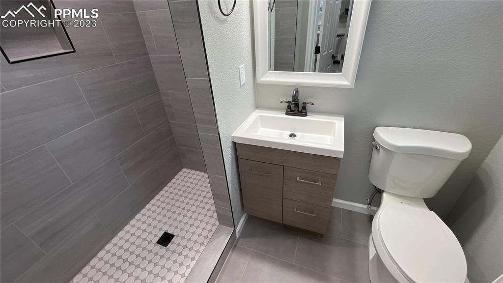 1219 Prairie Road Colorado Springs, CO 80909 - Photo 11 of 16 a bathroom with a sink toilet and shower