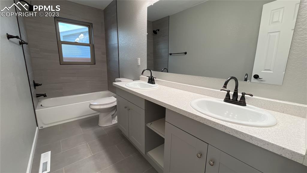 1219 Prairie Road Colorado Springs, CO 80909 - Photo 13 of 16 a bathroom with a sink and a mirror