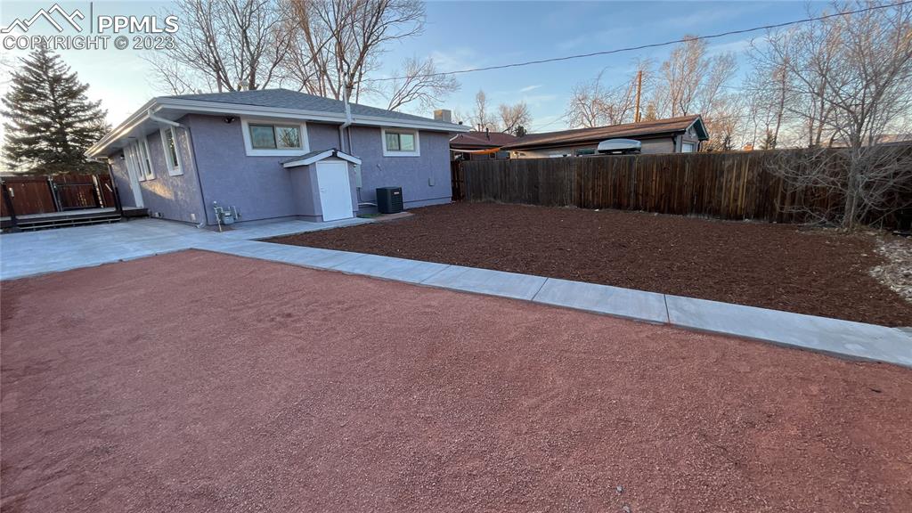 1219 Prairie Road Colorado Springs, CO 80909 - Photo 3 of 16 a front view of a house with a yard and garage
