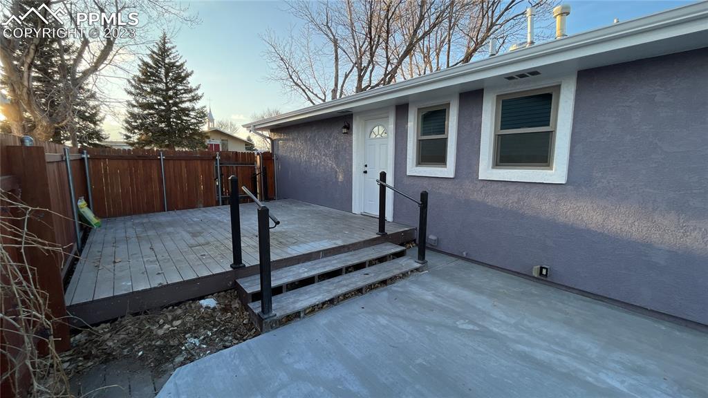 1219 Prairie Road Colorado Springs, CO 80909 - Photo 5 of 16 a view of backyard with wooden fence and large trees