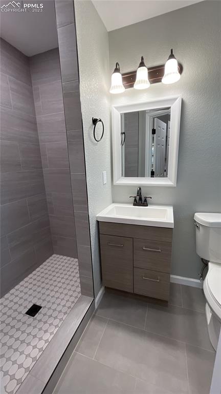 1219 Prairie Road Colorado Springs, CO 80909 - Photo 10 of 16 a bathroom with a sink a toilet and mirror