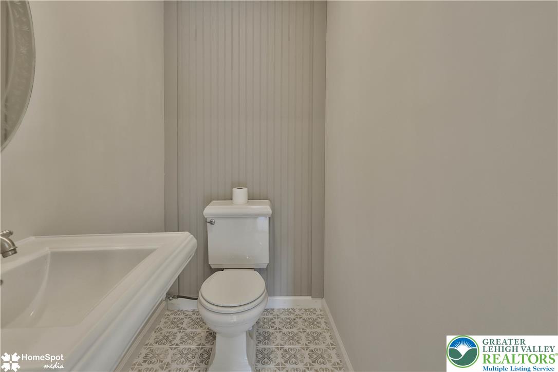 919 Point Phillips Road Bath, PA 18014 - Photo 26 of 59 A well-appointed lavatory features intricate patterned tile flooring and classic wainscoting.