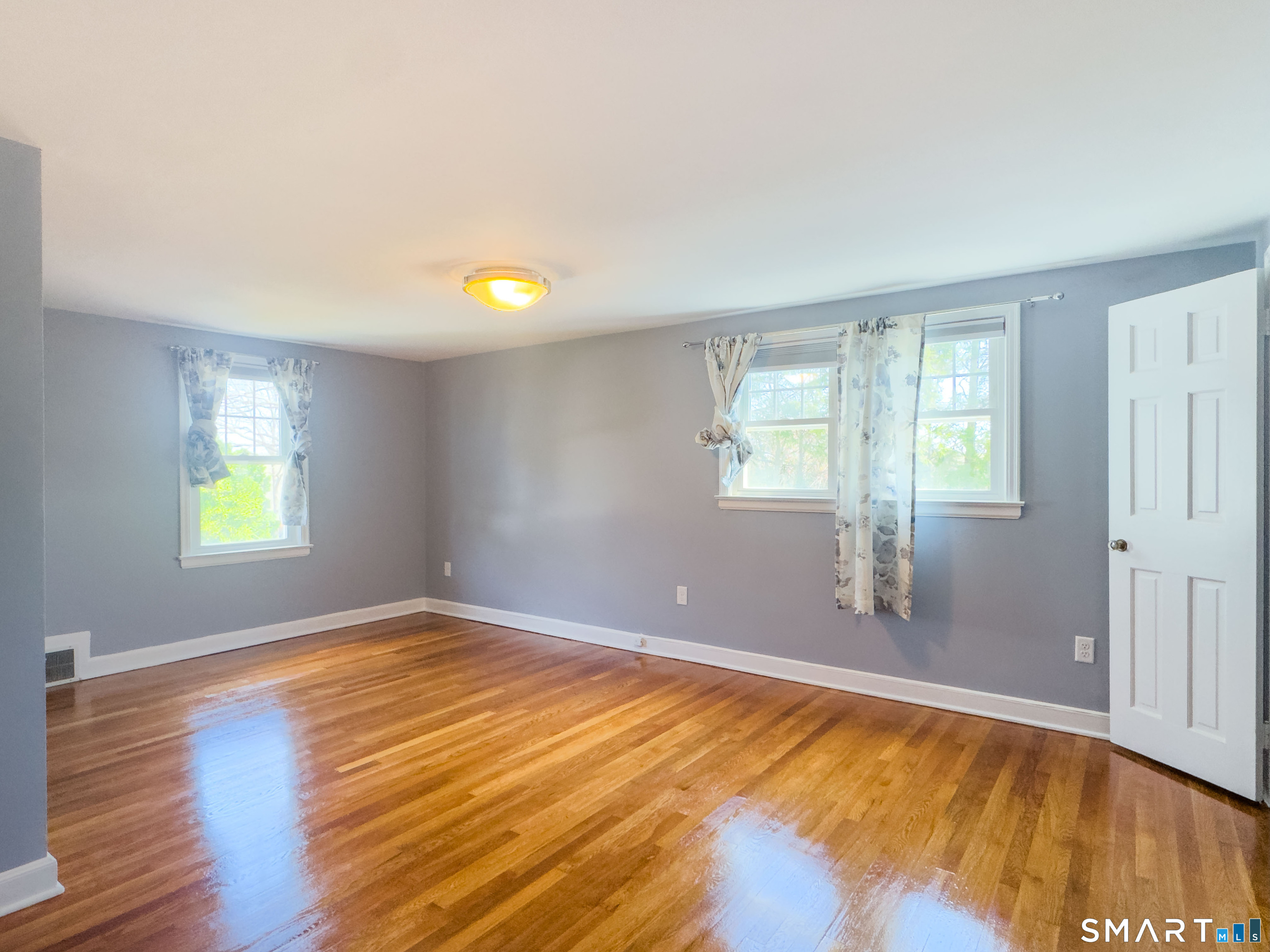 27 Glendale Drive Waterbury, CT 06708 - Photo 17 of 27 a view of an empty room with window and wooden floor