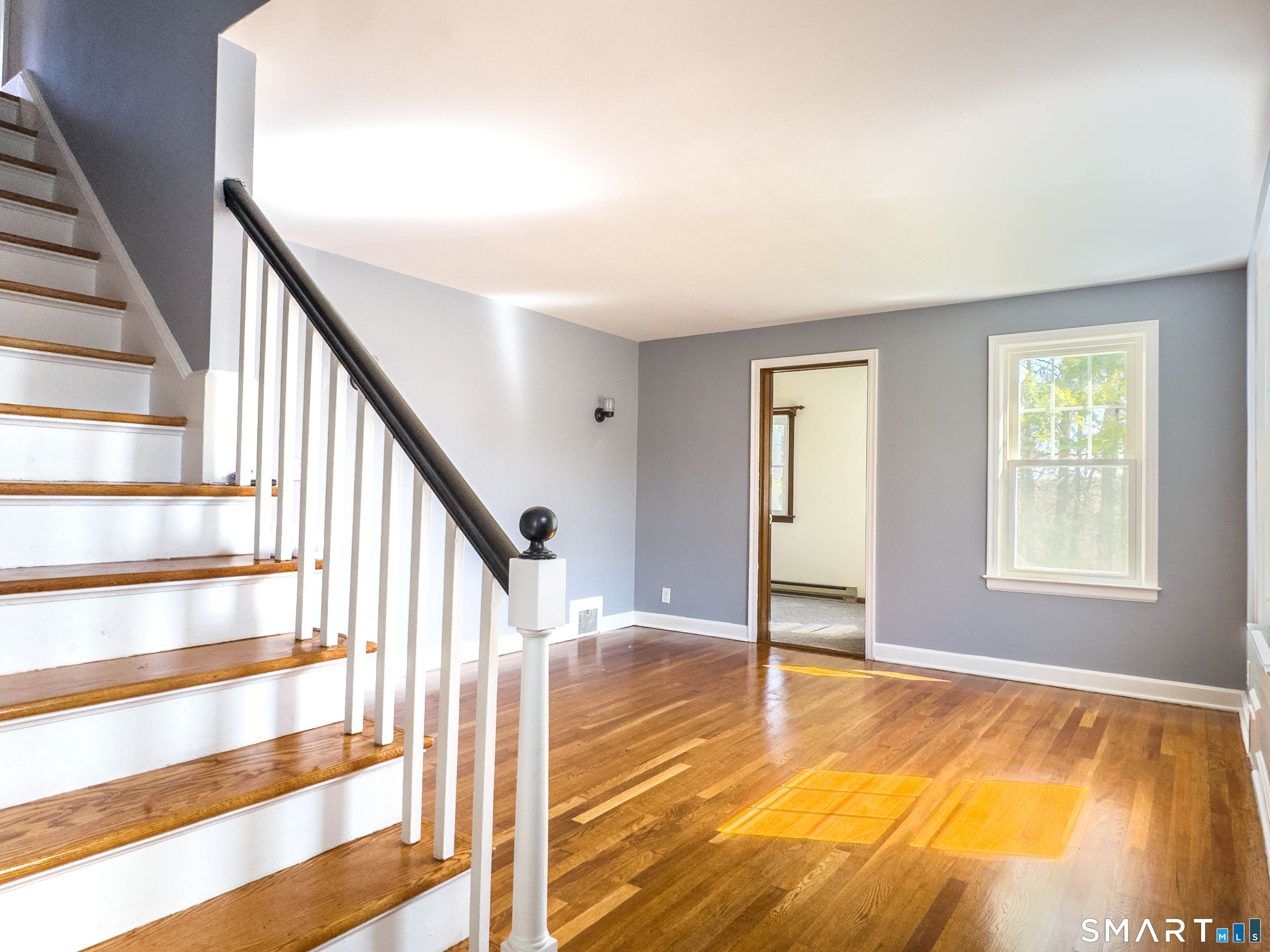 27 Glendale Drive Waterbury, CT 06708 - Photo 3 of 27 a view of an empty room with wooden floor and stairs