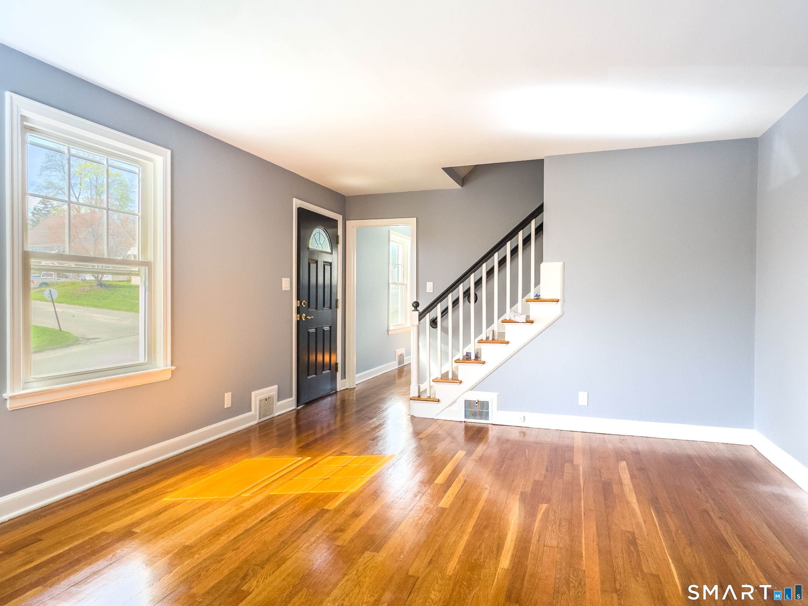 27 Glendale Drive Waterbury, CT 06708 - Photo 4 of 27 a view of an empty room with wooden floor and a window