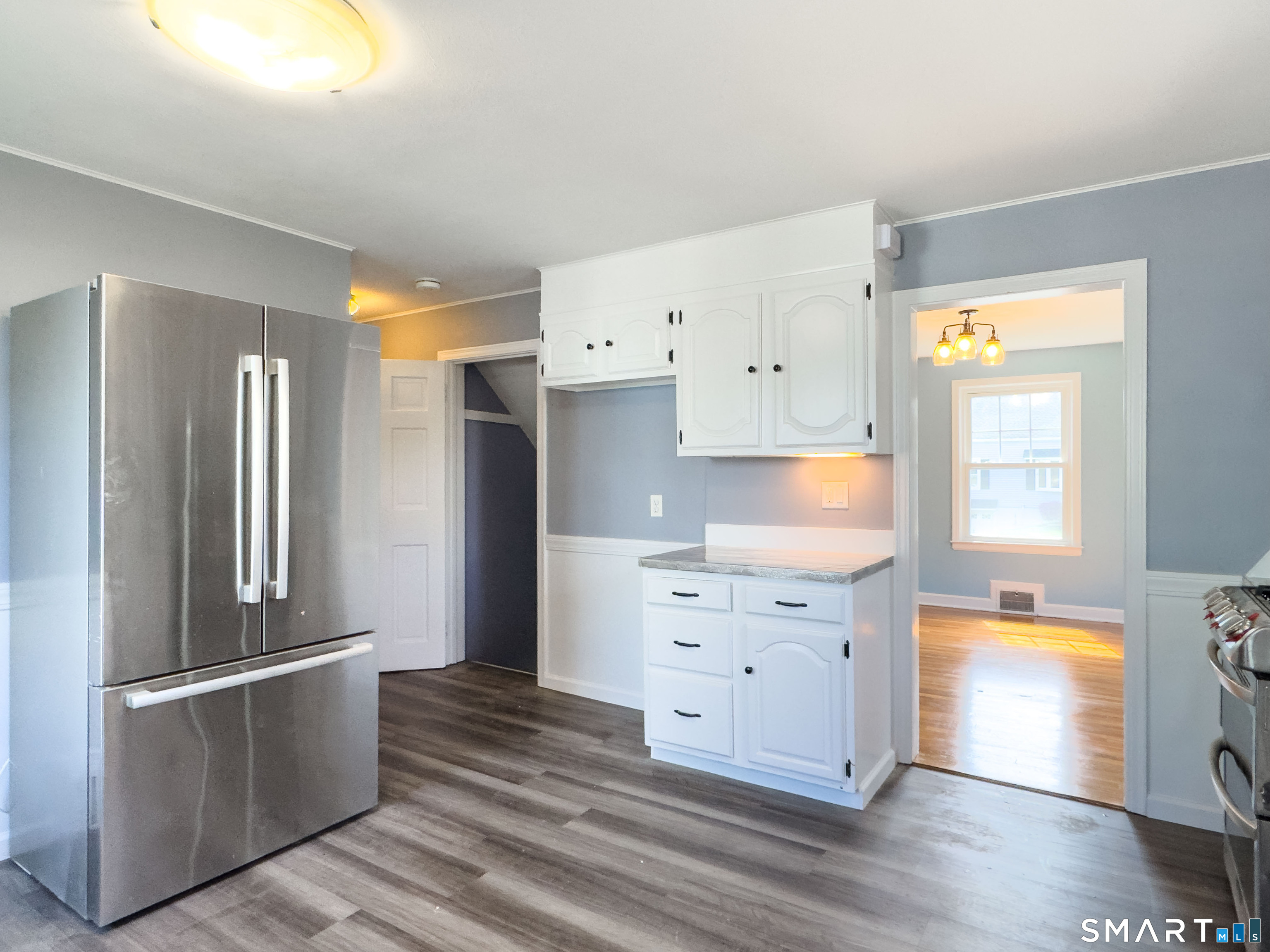 27 Glendale Drive Waterbury, CT 06708 - Photo 6 of 27 a kitchen with white cabinets and refrigerator