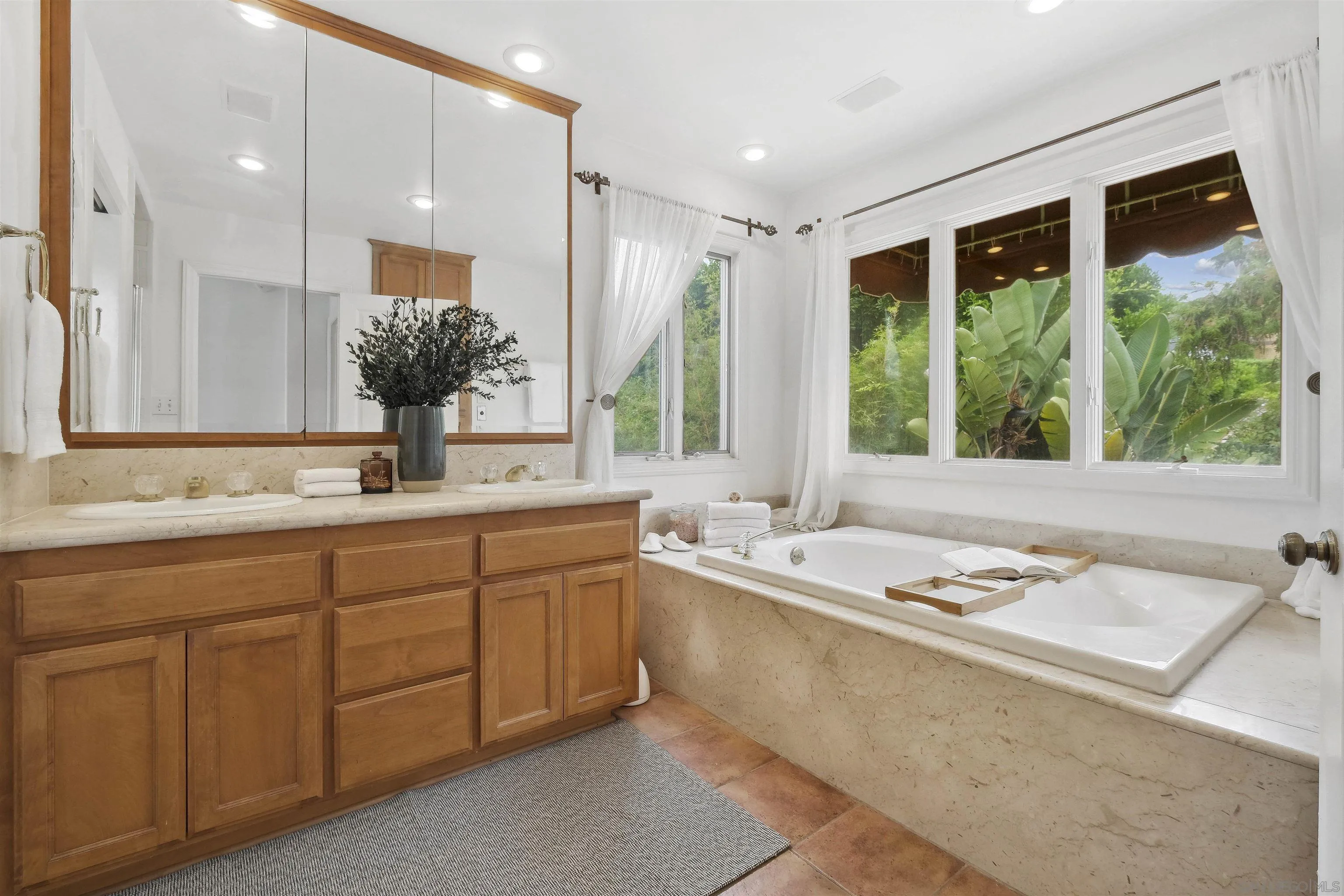 1937 Paseo Dorado La Jolla, CA 92037 - Photo 18 of 53 a bathroom with a sink and a large mirror next to a window