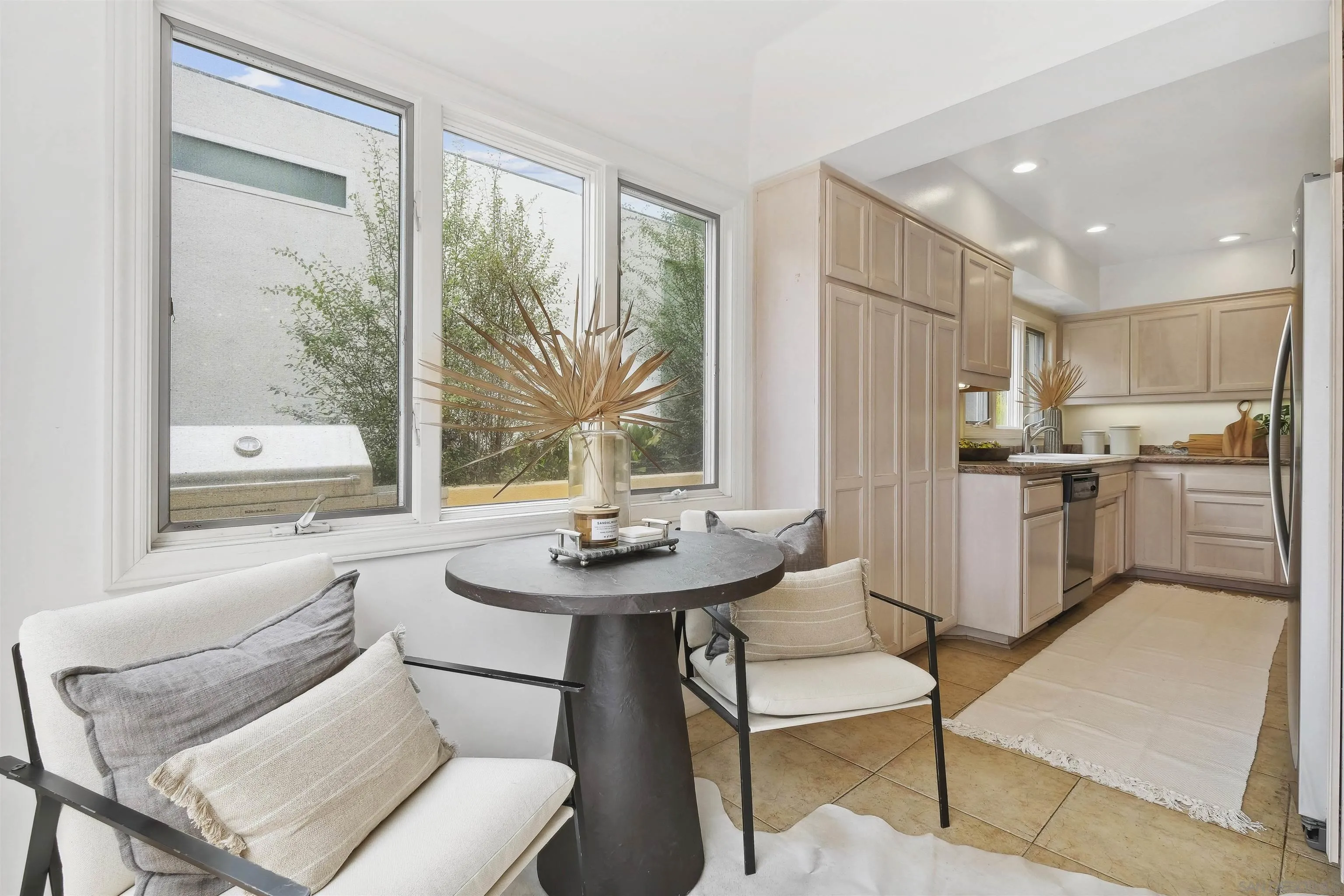 1937 Paseo Dorado La Jolla, CA 92037 - Photo 25 of 53 a kitchen with stainless steel appliances kitchen island granite countertop a table and chairs in it