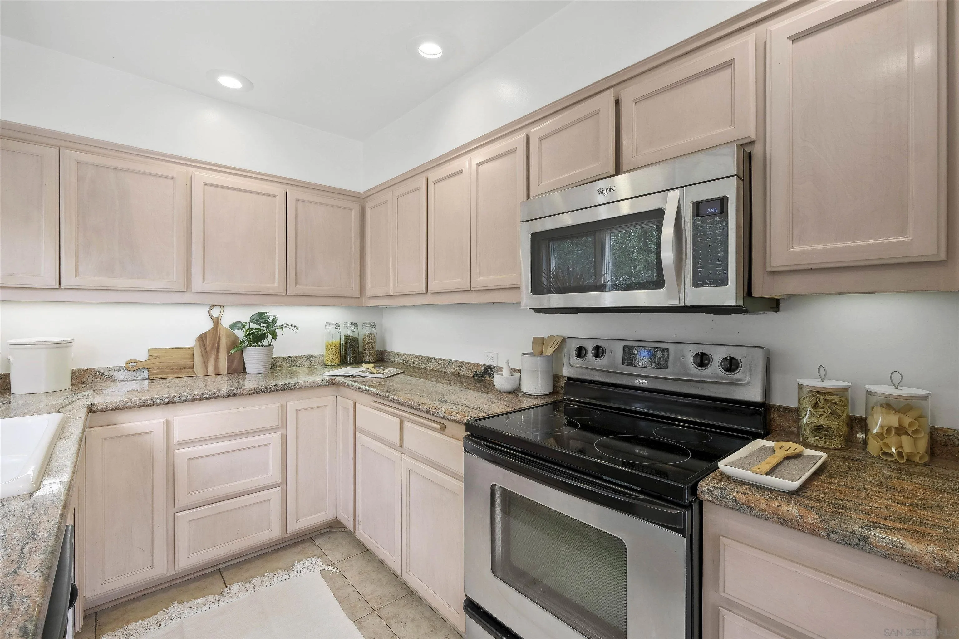 1937 Paseo Dorado La Jolla, CA 92037 - Photo 27 of 53 a kitchen with granite countertop white cabinets and stainless steel appliances