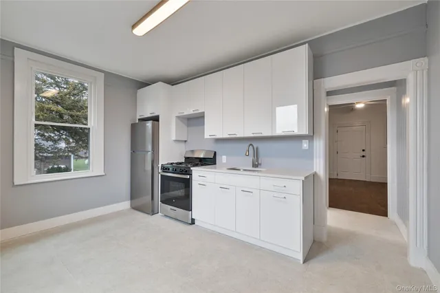 a kitchen with a stove a sink and a refrigerator