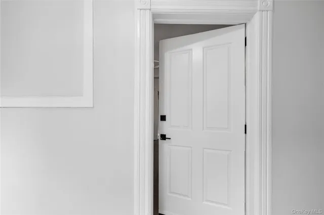 an empty room with closet and windows