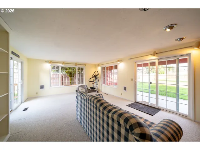 a bedroom with a bed and glass window