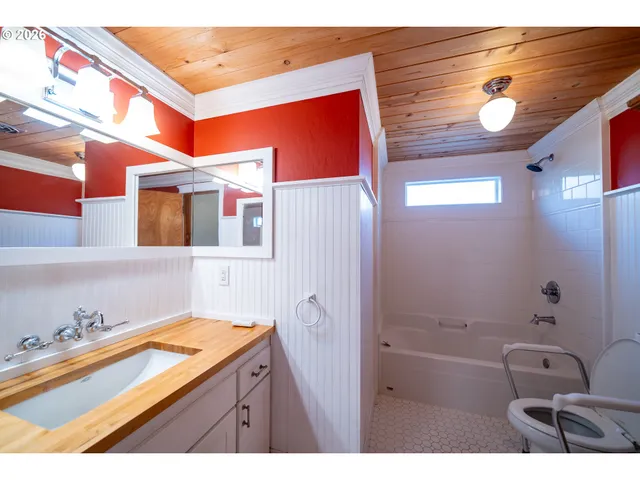 a bathroom with a sink a bath tub and a shower