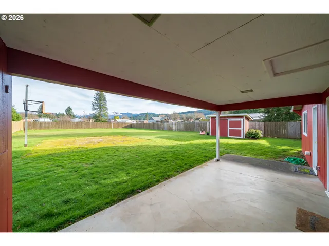 a view of a house with a yard and deck