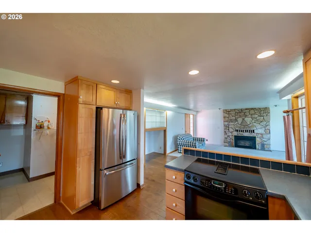 a kitchen with stainless steel appliances a refrigerator a stove a sink and a refrigerator