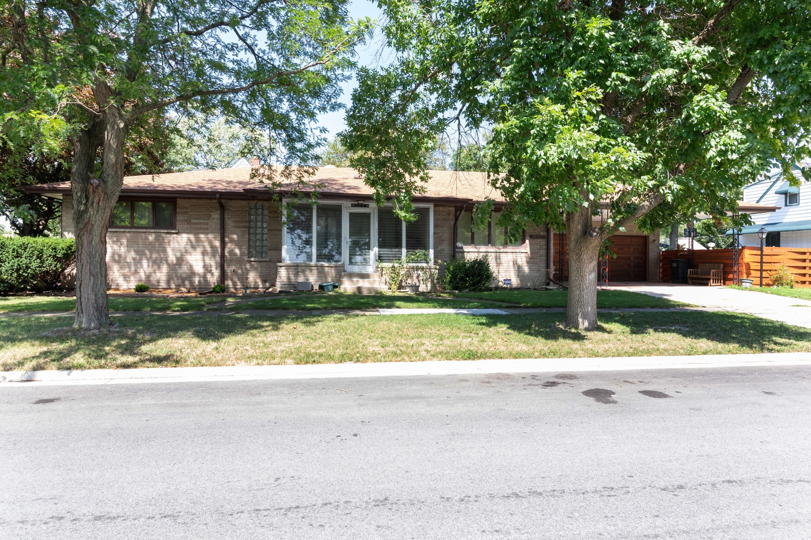 3604 177th Place Lansing, IL 60438 - Photo 1 of 13 a front view of a house with a yard table and chairs