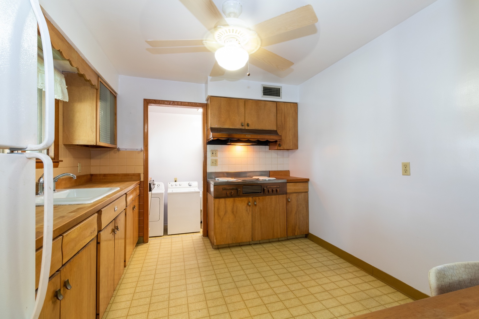 3604 177th Place Lansing, IL 60438 - Photo 4 of 13 a kitchen with stainless steel appliances granite countertop a sink a stove top oven a chimney and a refrigerator
