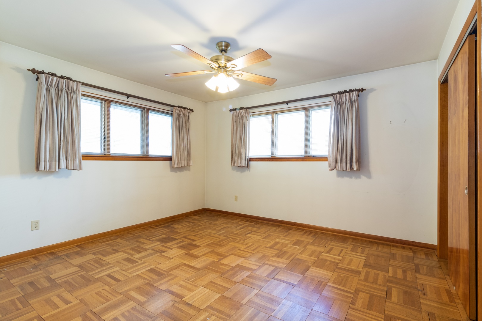 3604 177th Place Lansing, IL 60438 - Photo 7 of 13 a view of an empty room with wooden floor and a window