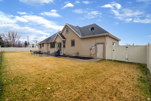 557 South 1470th Street East Springville, UT 84663 - Photo 40 of 46 Rear view of house featuring a gate, a fenced backyard, stucco siding, and a patio area