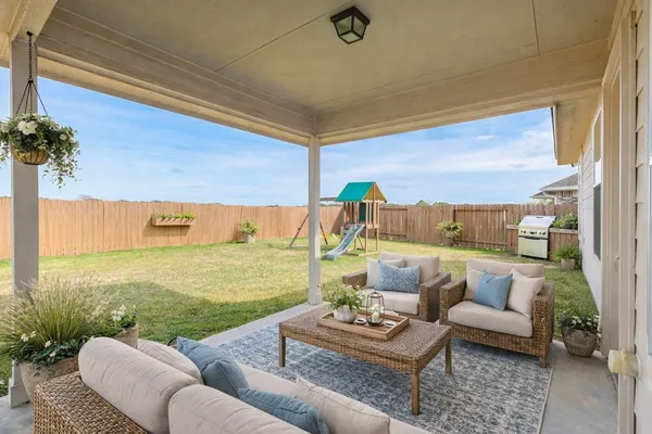 a balcony with furniture and a potted plant