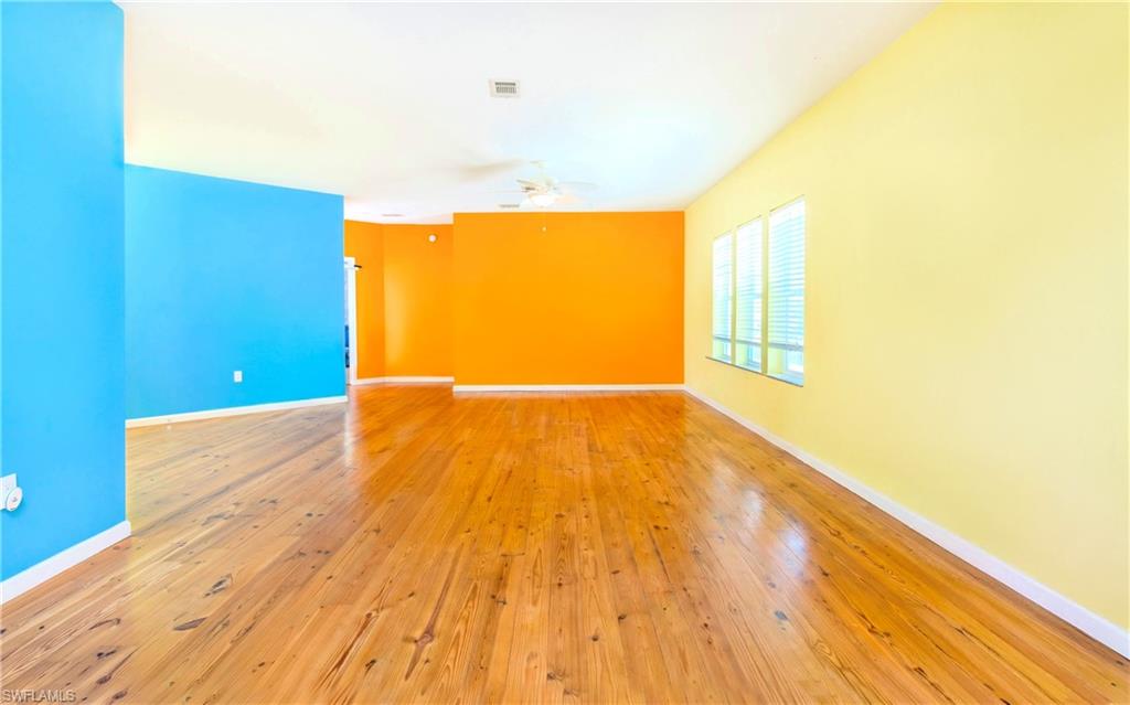 12277 Boat Shell Drive Matlacha Isles, FL 33991 - Photo 11 of 46 a view of a big room with wooden floor and windows