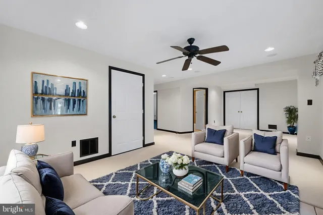 a view of empty room with windows and ceiling fan