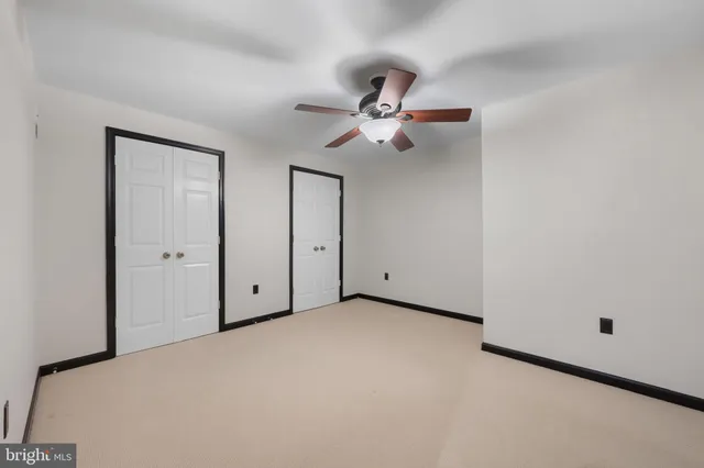 a view of a livingroom with a ceiling fan and window