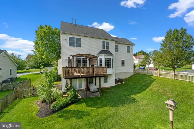 a front view of a house with a garden and deck