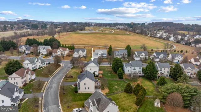 a front view of a house with a garden and plants