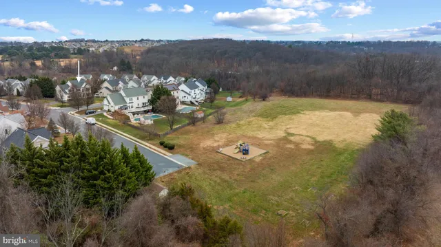 an aerial view of lake residential houses with outdoor space and swimming pool