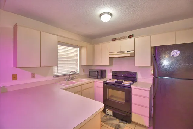 a kitchen with granite countertop a stove and a sink