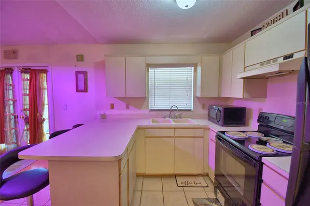 a kitchen that has a sink and a stove