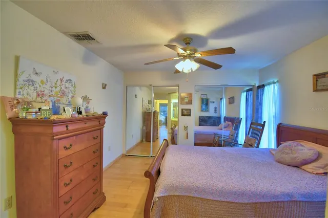 a bedroom with a large bed and a chandelier