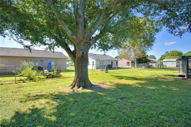 a view of a house with swimming pool and a big yard