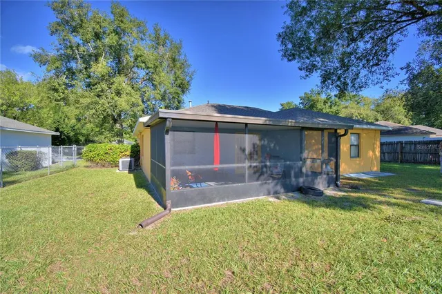 a view of a house with a yard and sitting area