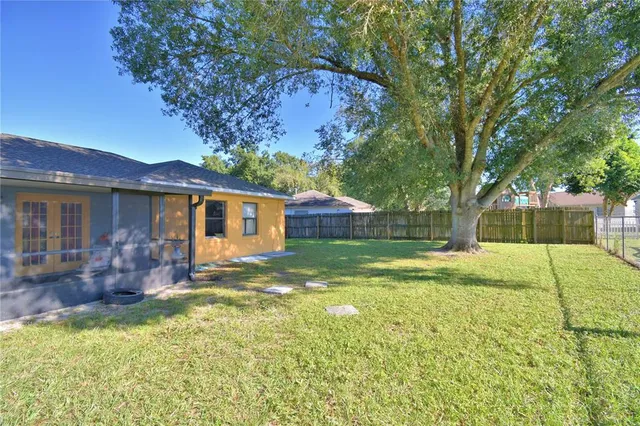 a view of a house with backyard and sitting area