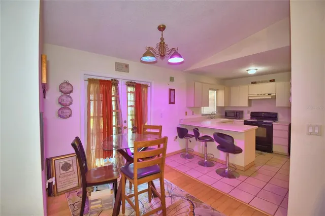 a large kitchen with a table and chairs