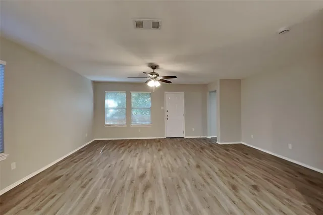 wooden floor in an empty room with a window