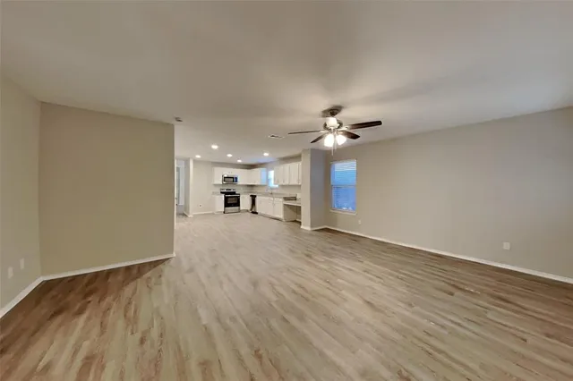 a view of a livingroom with a kitchen counter tops and a wooden floor