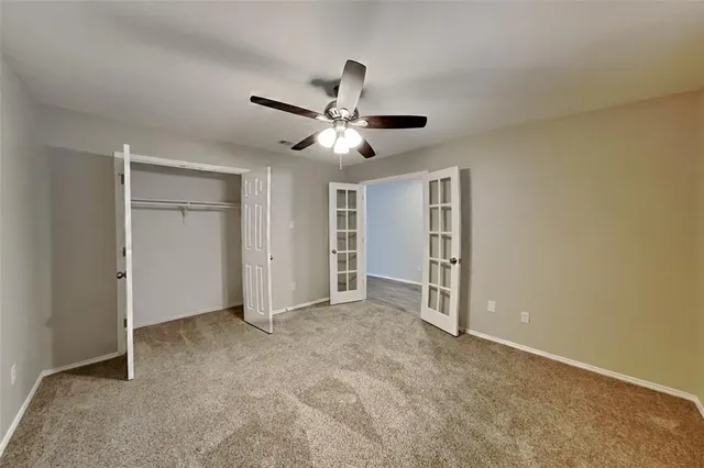 a view of empty room with ceiling fan